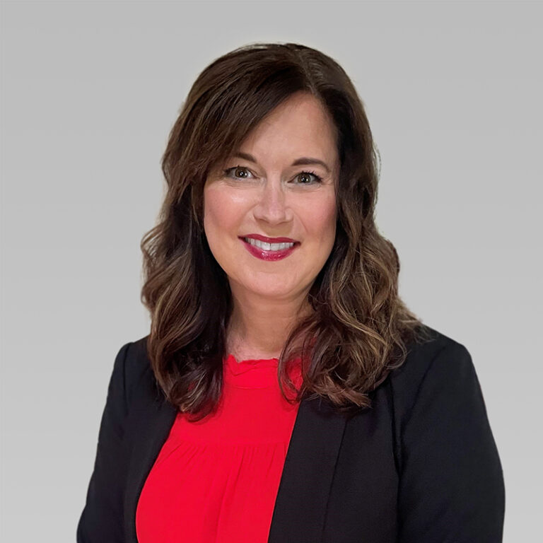 PCA Employee Ashley Kizzire on a grey background