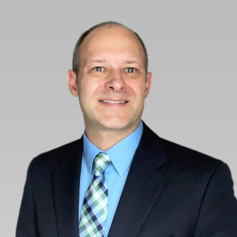 PCA Employee Eric Gianni on a grey background