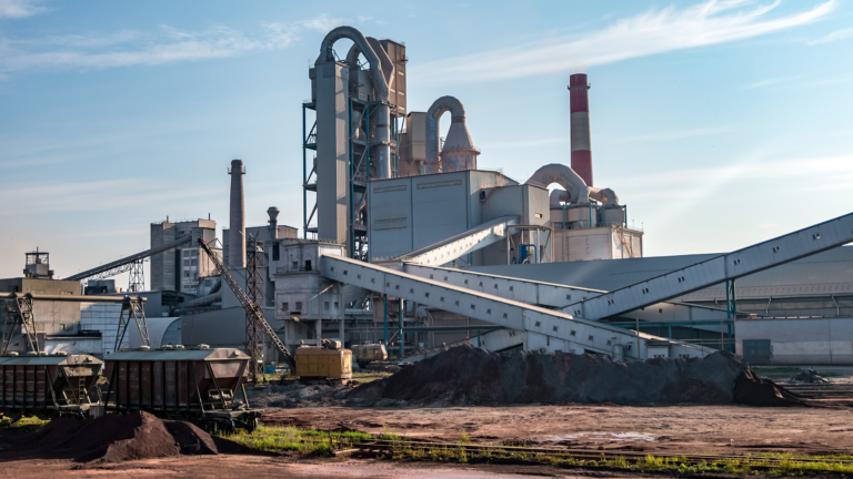 Big pipes of industry enterprise plant. mountains of sand and rubble